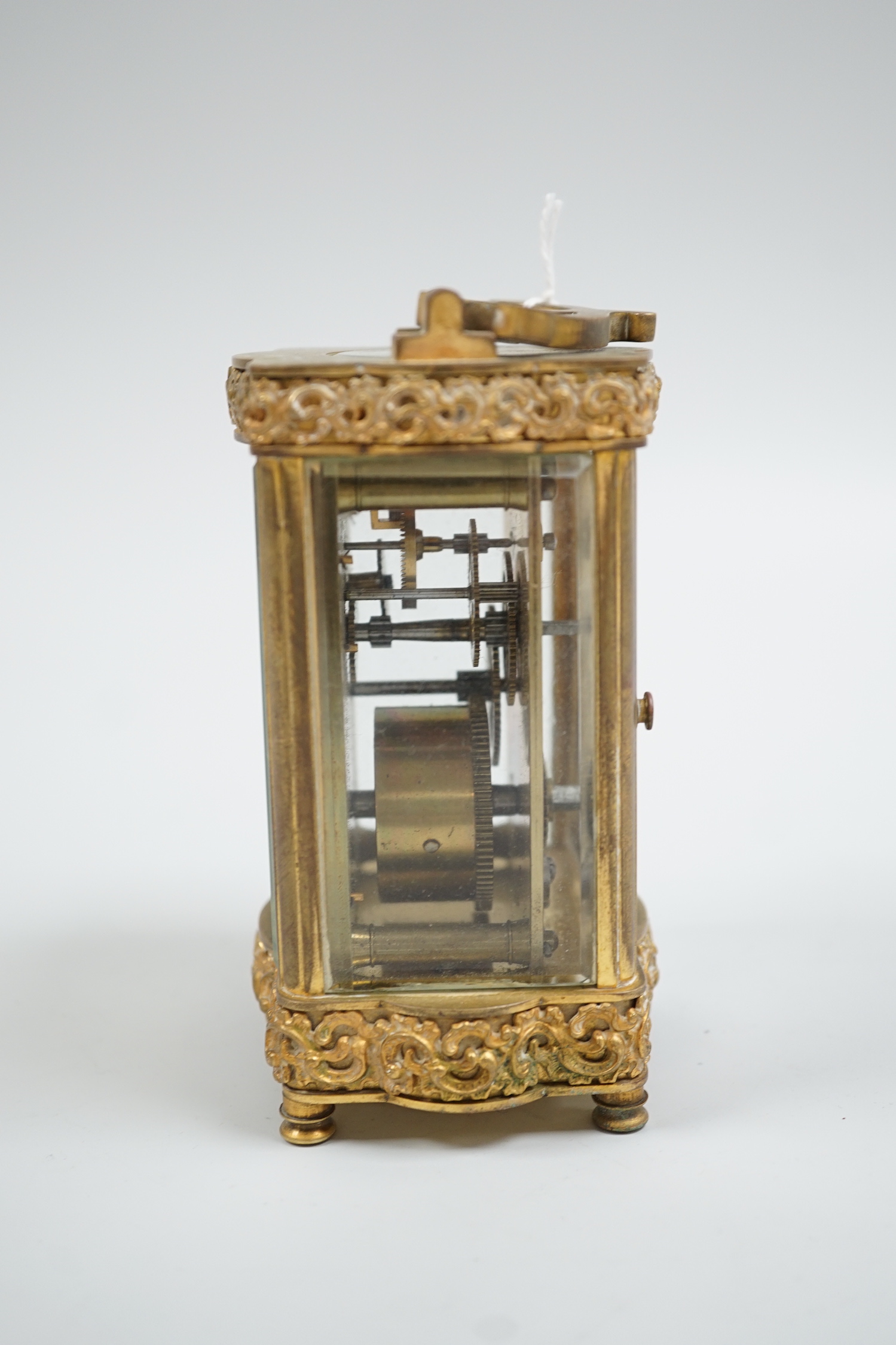 A French gilt brass serpentine carriage timepiece, 12cm high